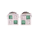 A pair of emerald and diamond stud earrings in 18ct white gold, each comprising two circular-cut