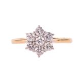 A diamond daisy cluster ring set with round brilliant cut diamonds with a total estimated diamond