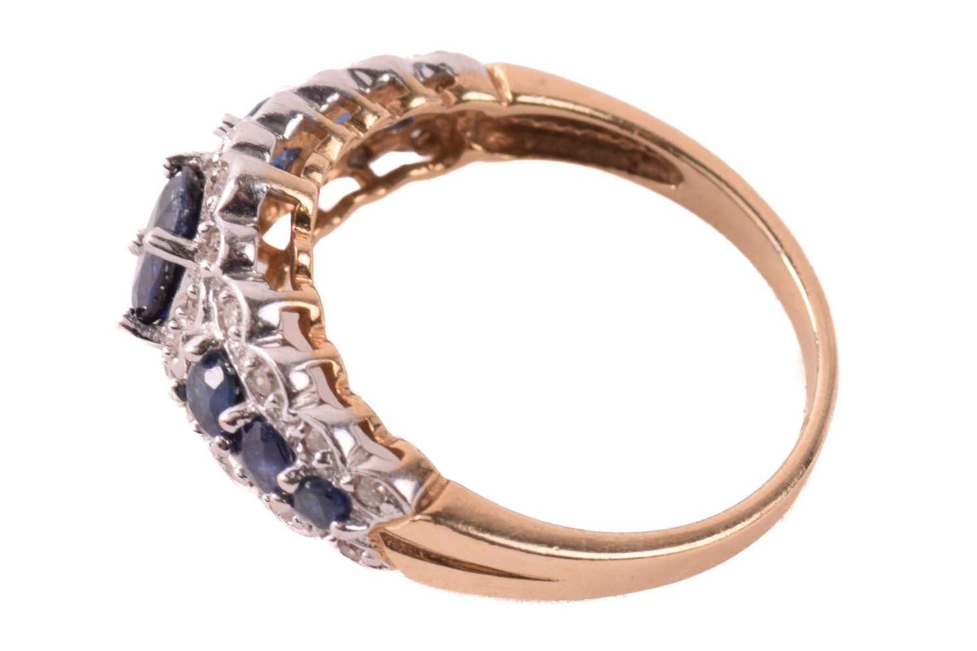 A sapphire and diamond dress ring in 9ct gold, claw-set with an oval-cut sapphire of 6.1 x 4.3 mm - Image 3 of 6