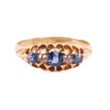 An Edwardian sapphire and diamond five stone half hoop ring, the central sapphire measuring 3.8mm