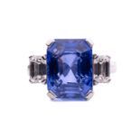 A sapphire and diamond trilogy ring, featuring a large colour-change sapphire in octagonal-cut