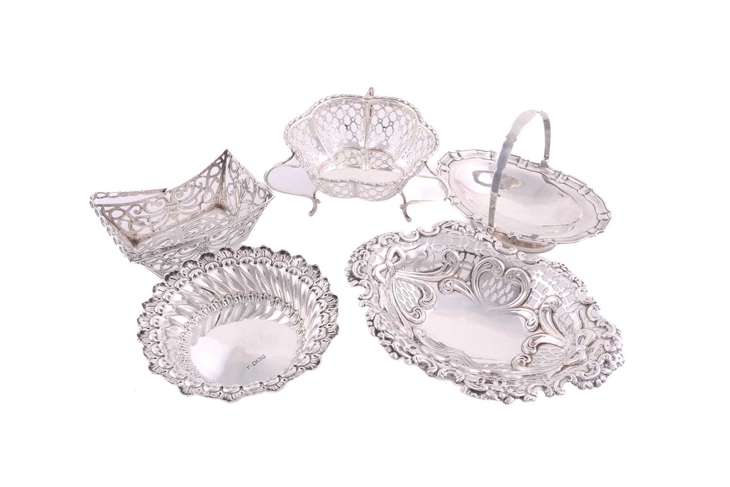 Five assorted silver bon bon dishes comprising two with swing handles (the oval example with