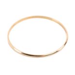An 18ct yellow gold closed bangle, with a solid D-profile band, marked '750 OBLO' with London import