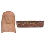 A Greek terracotta head of a Kore displaying moulded headdress and enigmatic smile (old repairs