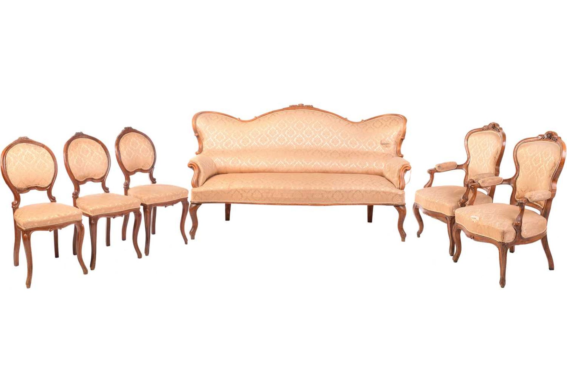 A 19th century matched salon suite, the three-seat settee with shaped back surmounted by a rose