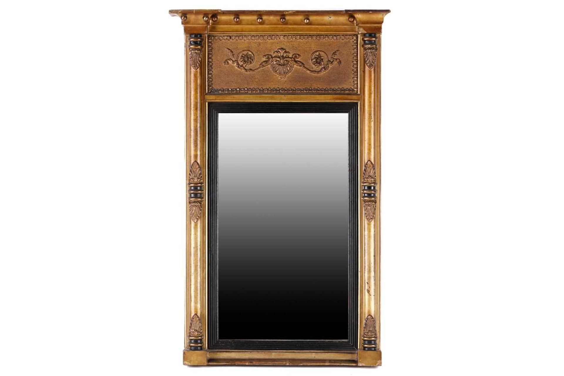 A Regency carved wood and gilt gesso pier glass, the inverted breakfront frame with sphere set