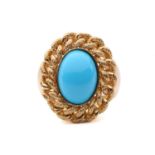 A turquoise dress ring, centred with an oval turquoise cabochon, collet set within a textured curb