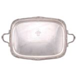 A silver twin handled tea tray, by the Goldsmiths and Silversmiths Company, London 1932, rounded