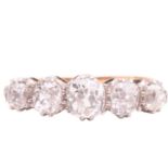 A diamond five stone ring, set with a graduated row of cushion shape old cut diamonds with a total