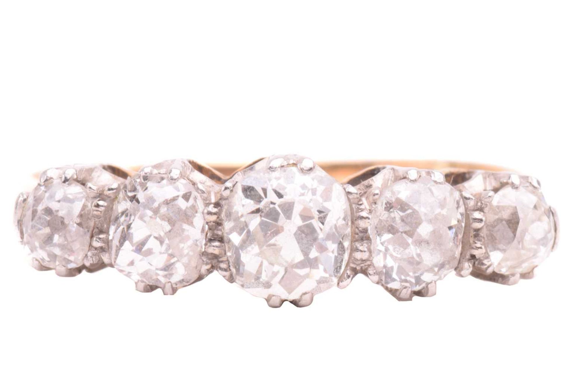 A diamond five stone ring, set with a graduated row of cushion shape old cut diamonds with a total