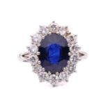 A sapphire and diamond cluster ring, set to the centre with an oval sapphire measuring 11.1 x 8.7