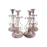 A set of four Victorian silver-plated candlesticks, possibly old sheffiled plate, each having an