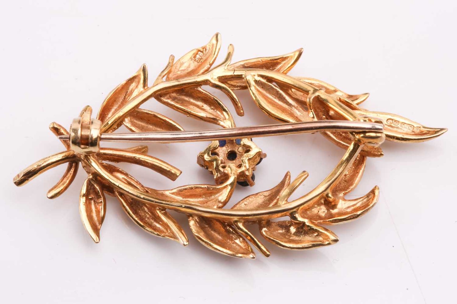 A gold and sapphire spray brooch by Cropp & Farr, designed as a spray of foliage with a sapphire - Image 2 of 2