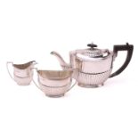 A George IV-style three-piece silver tea set, with makers mark A W | J H, Sheffield 1921, of oval