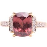 A red zircon and diamond dress ring in 18ct yellow gold, centred with a cushion-cut red zircon in