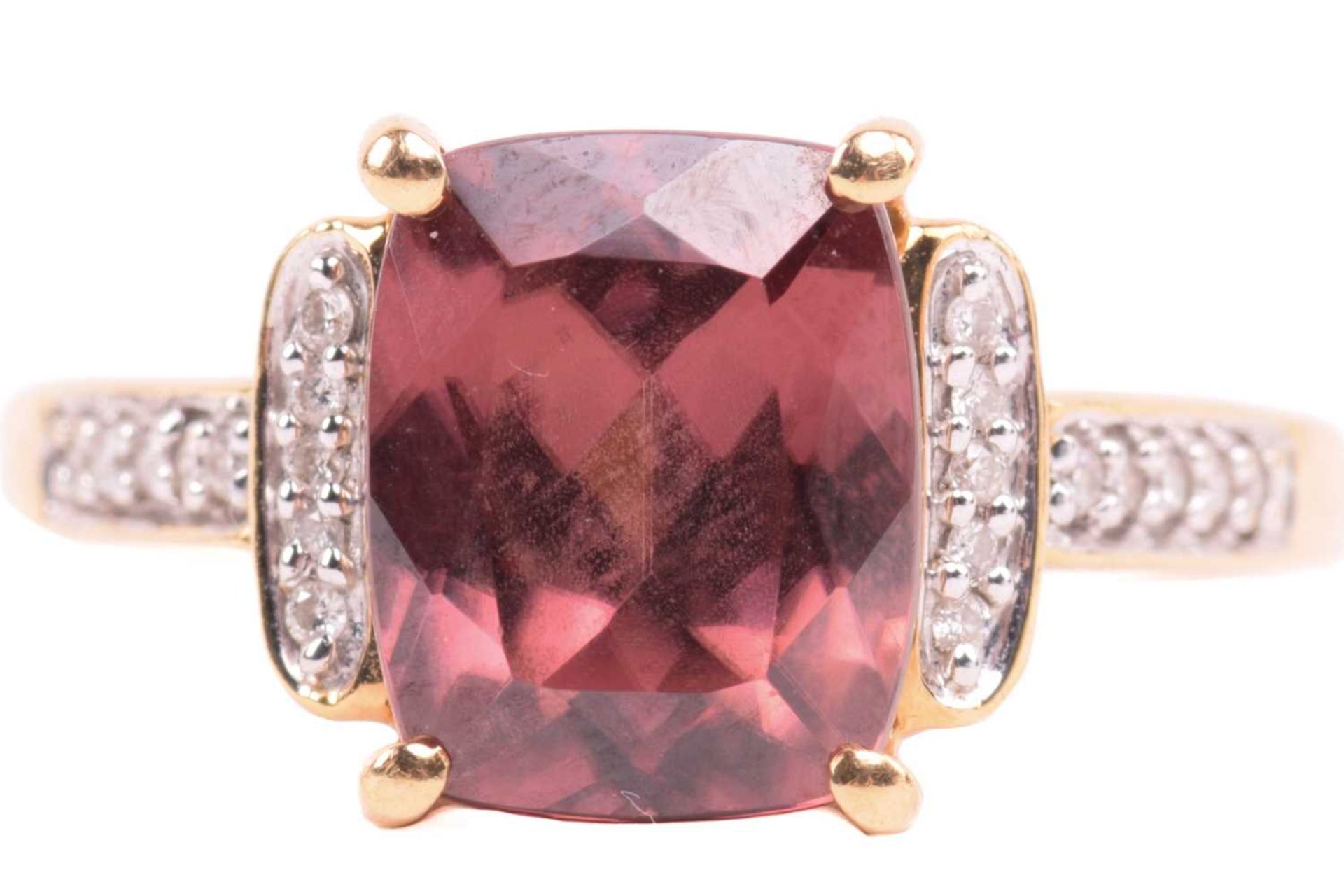 A red zircon and diamond dress ring in 18ct yellow gold, centred with a cushion-cut red zircon in