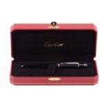 A Cartier Diabolo ballpoint pen, with black body and silver plated mounts, with blue cabochon set