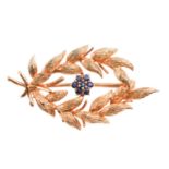 A gold and sapphire spray brooch by Cropp & Farr, designed as a spray of foliage with a sapphire