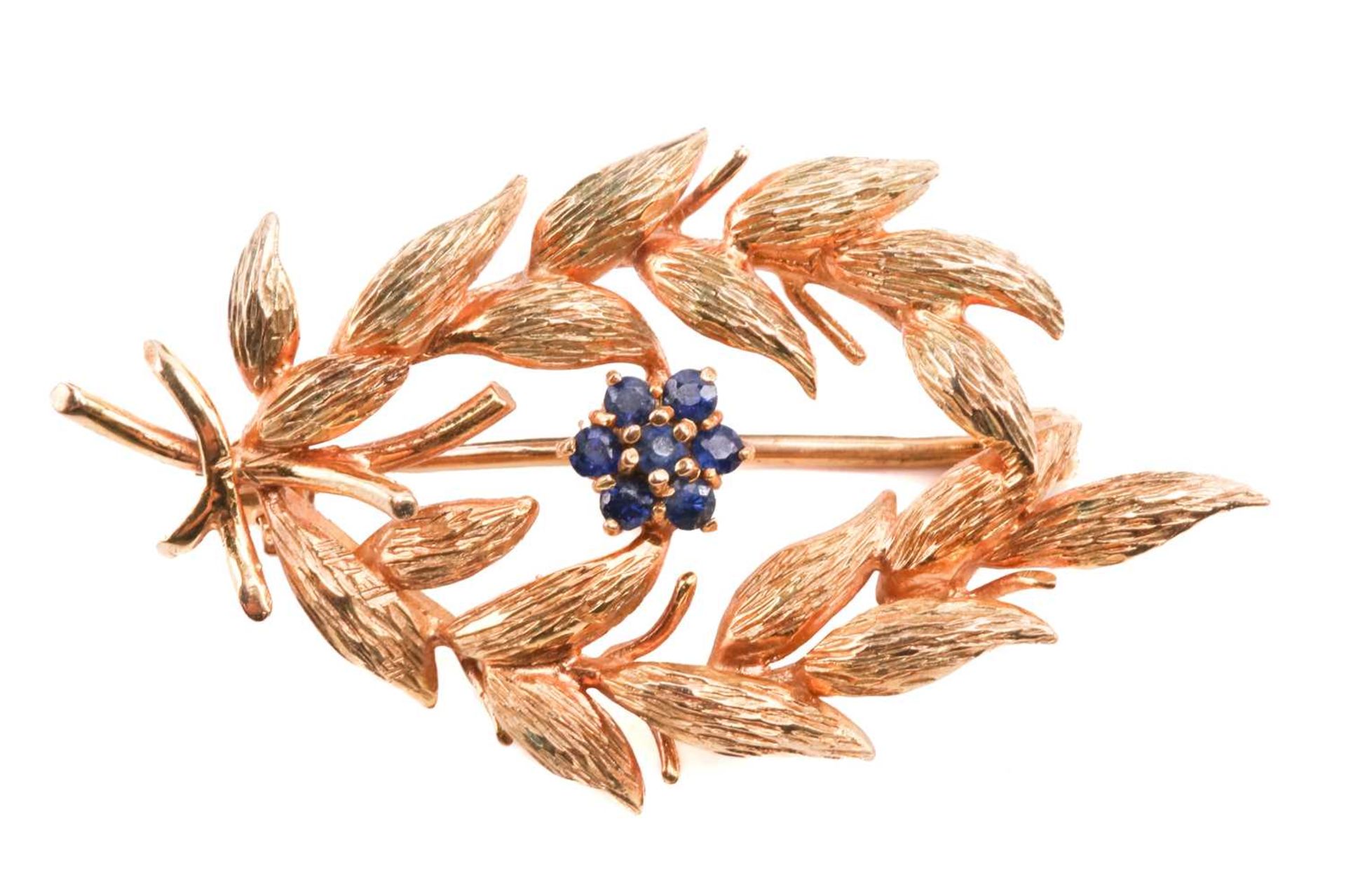A gold and sapphire spray brooch by Cropp & Farr, designed as a spray of foliage with a sapphire