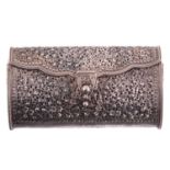 A white metal clutch bag; chased and pierced foliate decoration; hinged cover and hinged clasp.