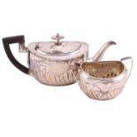 A Victorian silver part-fluted teapot with angular ebonised handle, hinged cover and engraved