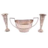 A silver half-reeded sugar basin engraved with a dedication, 6.4ozt together with two weighted