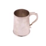 A silver tankard of plain tapering cylindrical form the handle with inverted thumb piece, 11.5cm