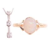 An opal dress ring in 9ct gold and a diamond pendant on chain; the ring contains an oval cabochon of
