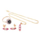 A ruby necklace and earrings ensuite together with a dress ring; the pendant set with three oval-cut