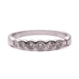 A diamond seven stone half hoop eternity ring, featuring a row of round brilliant cut diamonds