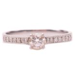 A single stone diamond ring, the round brilliant cut diamond in simple four claw mount, with diamond