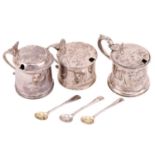Three silver mustard pots with hinged covers and blue glass liners, one with a shell thumb piece,