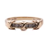 A channel-set diamond ring in 14ct yellow gold, comprising three cross-lashing motifs, flanked by