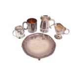 A silver salver on four ball and claw feet together with three 20th-century silver mugs, the small