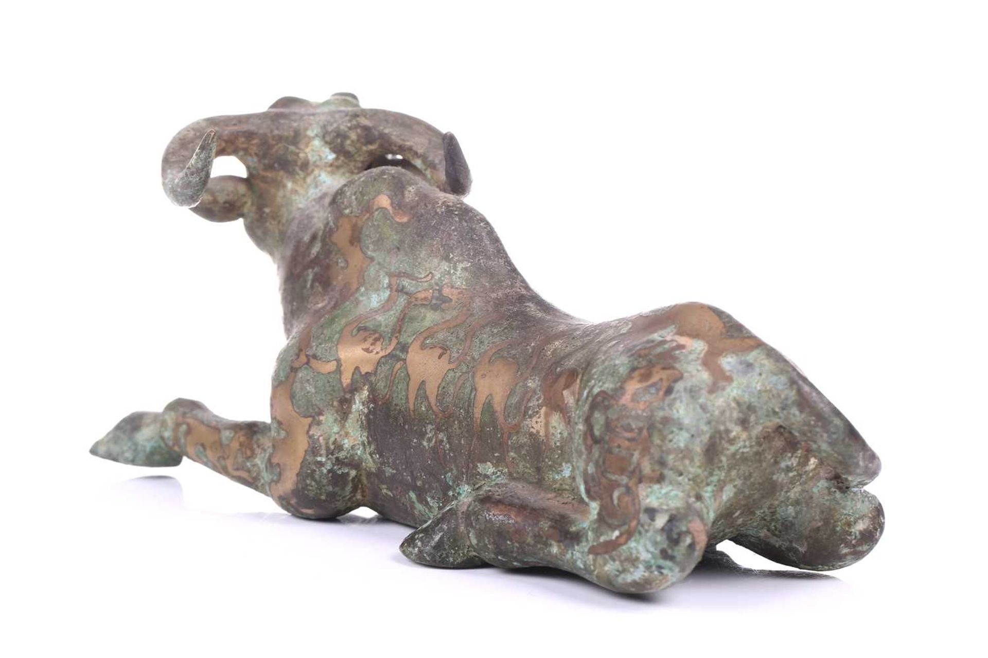 A Chinese bronze and gilt recumbent bull, possibly Zhou dynasty or later, the animal with one leg - Image 5 of 20