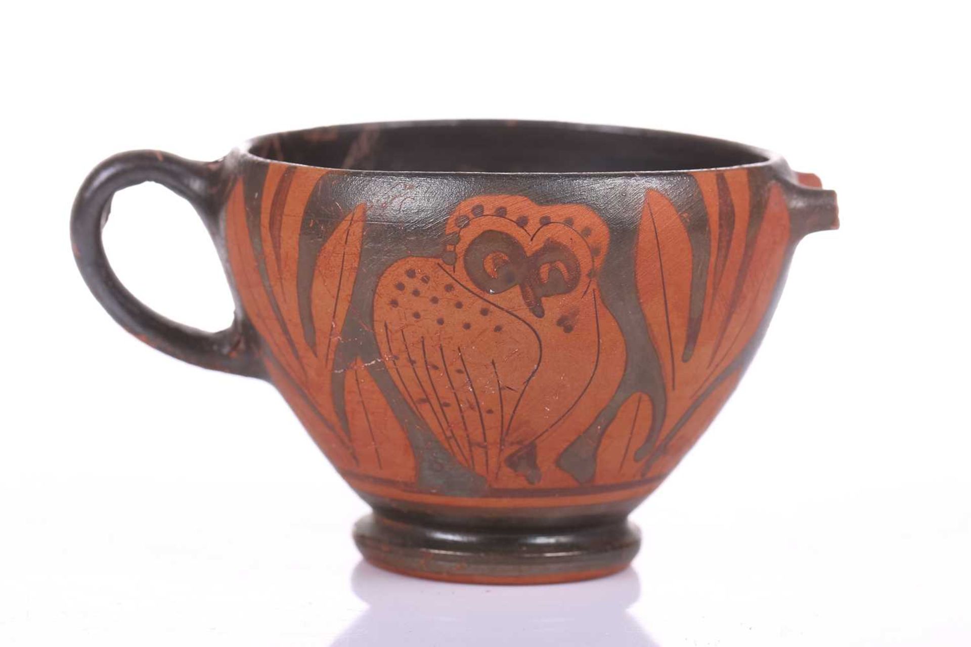 An Athenian-style ritual cup, 4th century BC or later, decorated with the "Owl of Athena" amidst
