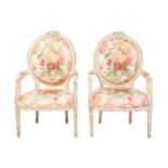 A pair of Louis XVI-style carved painted and distressed fauteuils, 20th century, with cameo-shaped