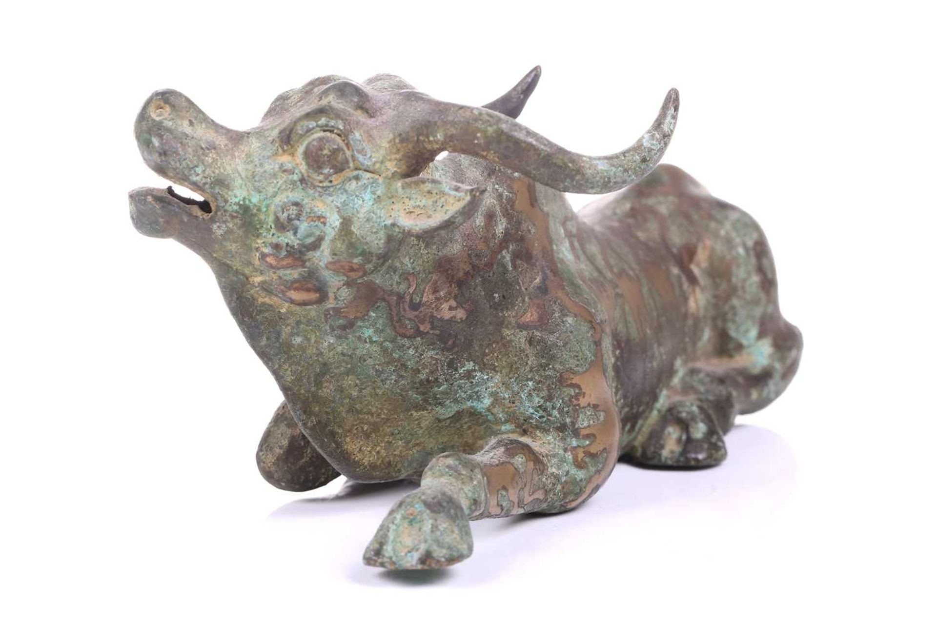 A Chinese bronze and gilt recumbent bull, possibly Zhou dynasty or later, the animal with one leg - Image 3 of 20