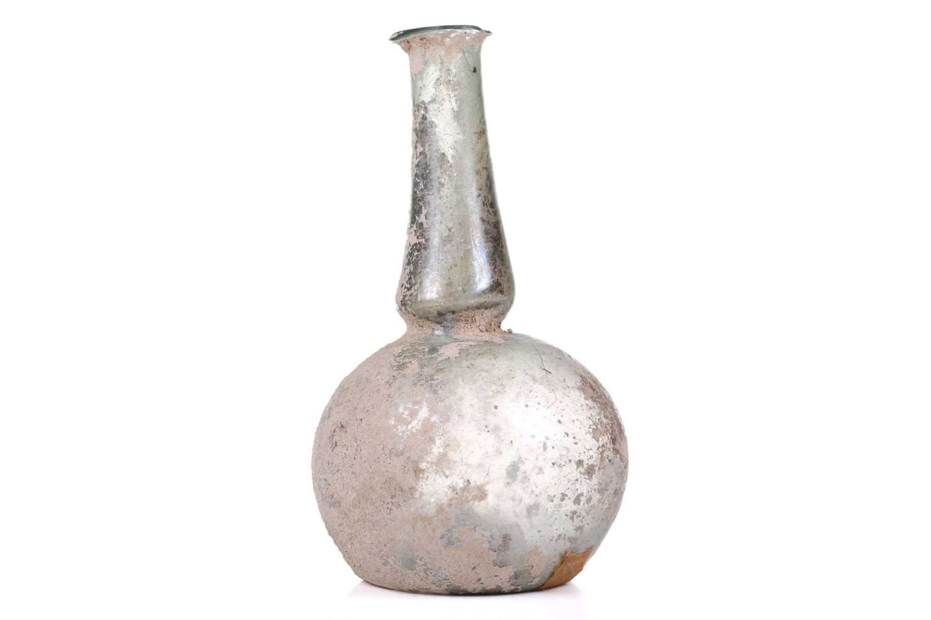 A Roman glass bulbous flask with everted rim, signs of oxidation and encrusted soil to the - Image 2 of 6