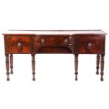 A William IV mahogany breakfront sideboard, the top with plate rest to the back over a bowed