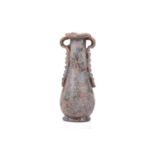 A Roman glass oil flask with a pair of applied ribbon form handles and everted rim over an