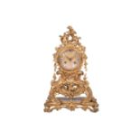 A late 19th century French ormolu clock, with floral garlands and scrolls, the gilt metal dial