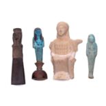 An Egyptian basalt-type Shabti with a hieroglyphic panel to the torso mounted in an old museum-