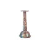 A Roman glass Unguentarium flask with rolled everted rim and stepped conical body, with an