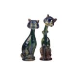 A pair of earthenware winking cat candlesticks, in blue and green glaze, one with impressed 5