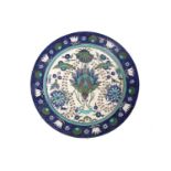 A Torquato Castellani Faience Charger, with blue and turquoise Iznik style floral design, within a