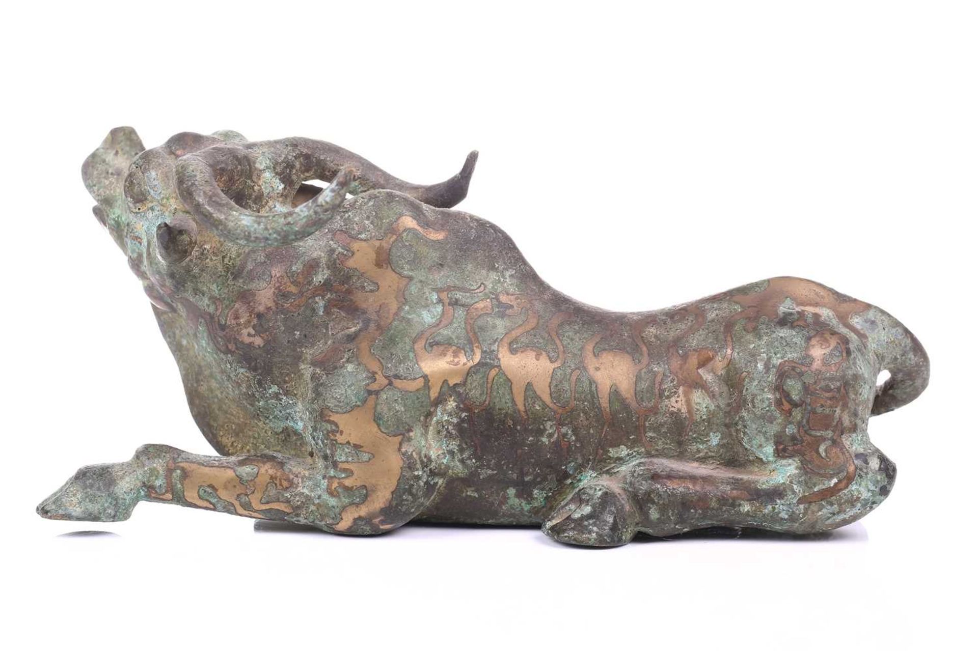 A Chinese bronze and gilt recumbent bull, possibly Zhou dynasty or later, the animal with one leg - Image 4 of 20