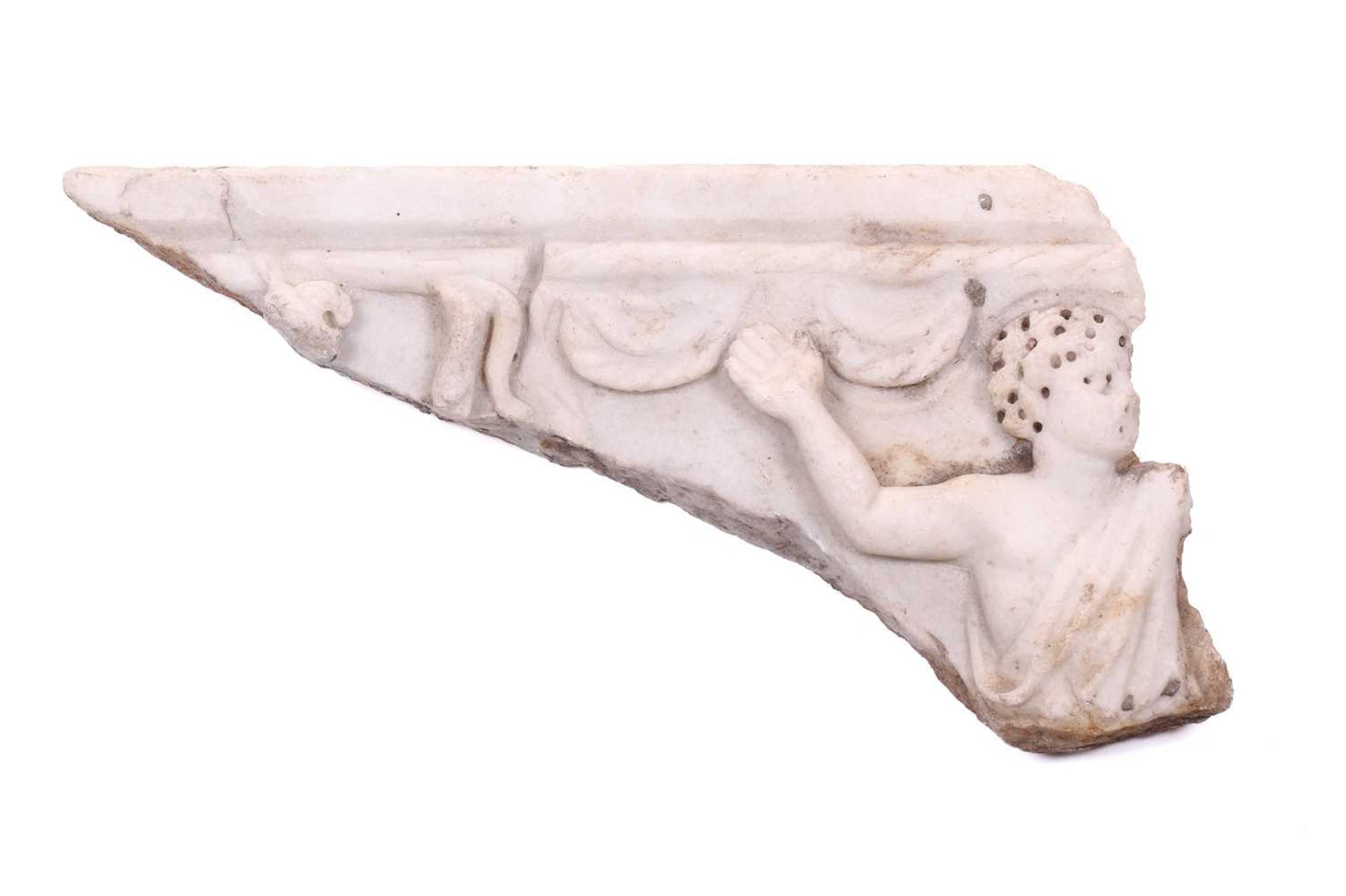 A Roman Marble fragment, 2nd/3rd century AD, possibly part of a sarcophagus, depicitng a youth in