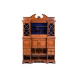 A fine Edwardian mahogany and inlaid inverted breakfront side cabinet, the arched broken pediment