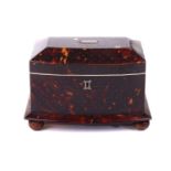 An early Victorian tortoiseshell tea caddy, with silver pique decoration and slightly bowed front,